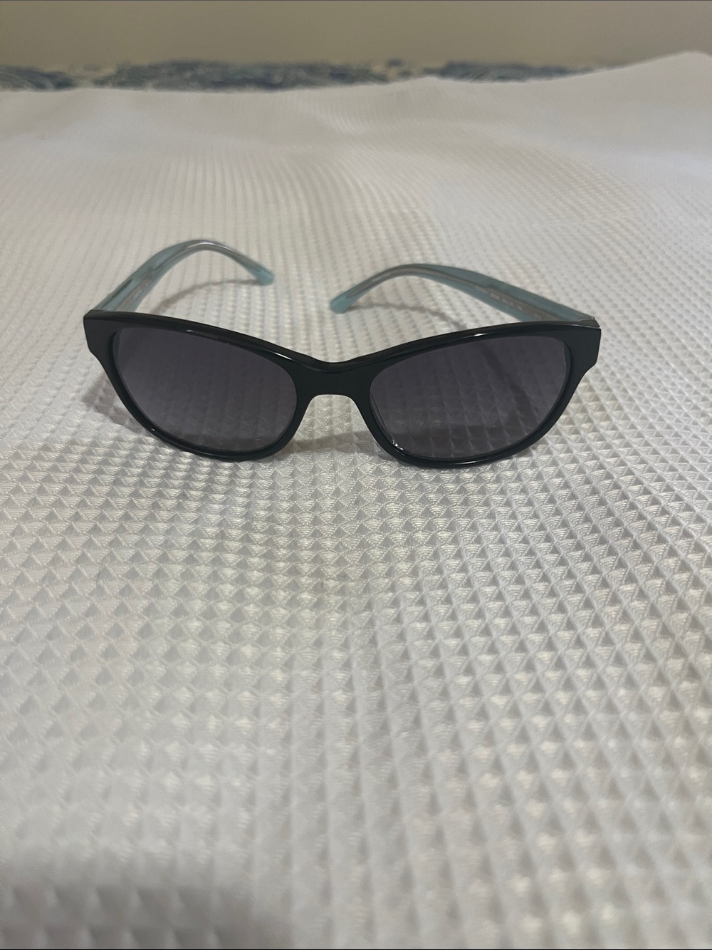 bebe Black Frame Sunglasses with Light Blue Arms and Floral Detail